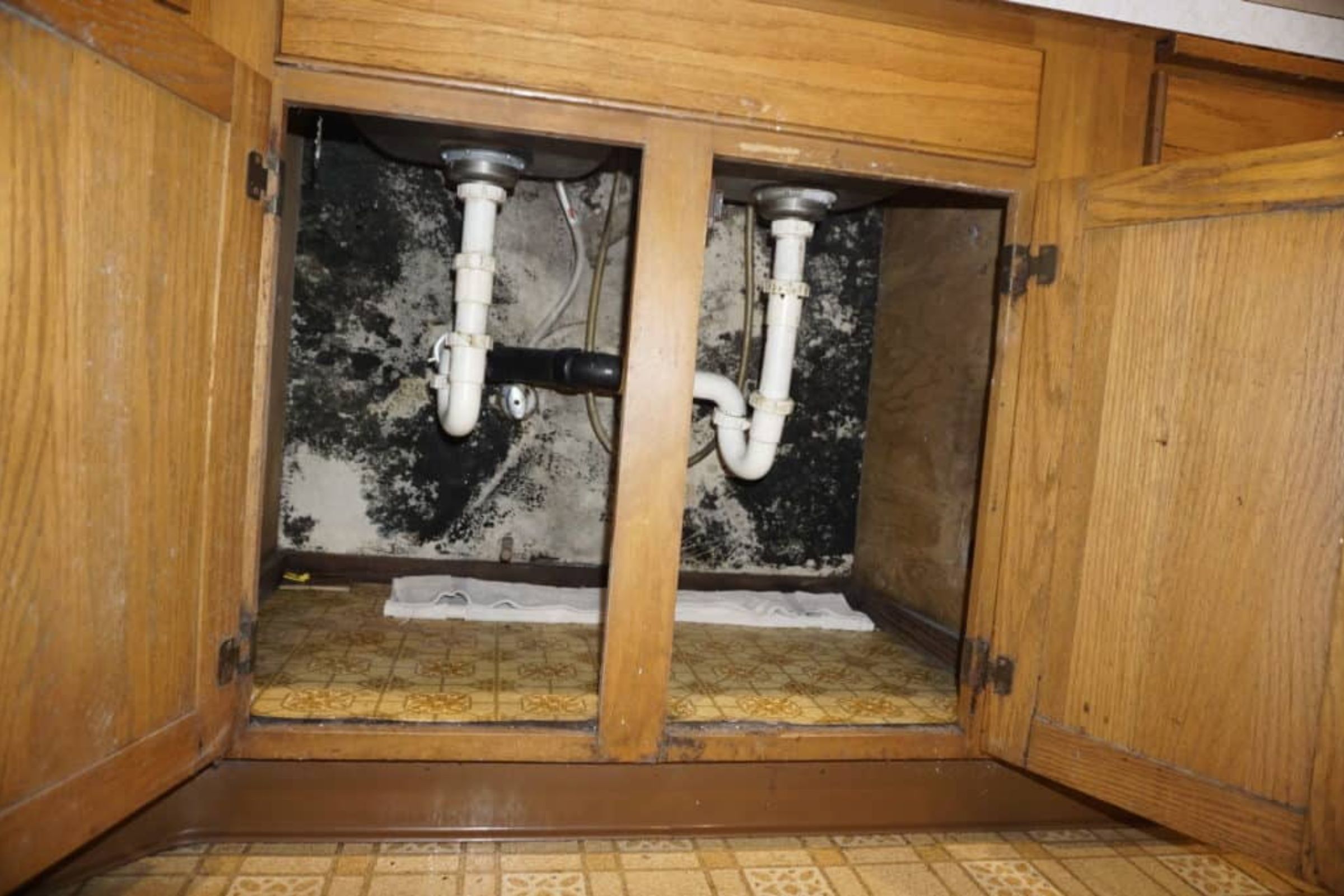 Kitchen sink and pipes, illustrating a basement mold removal service based in Joliet, IL.
