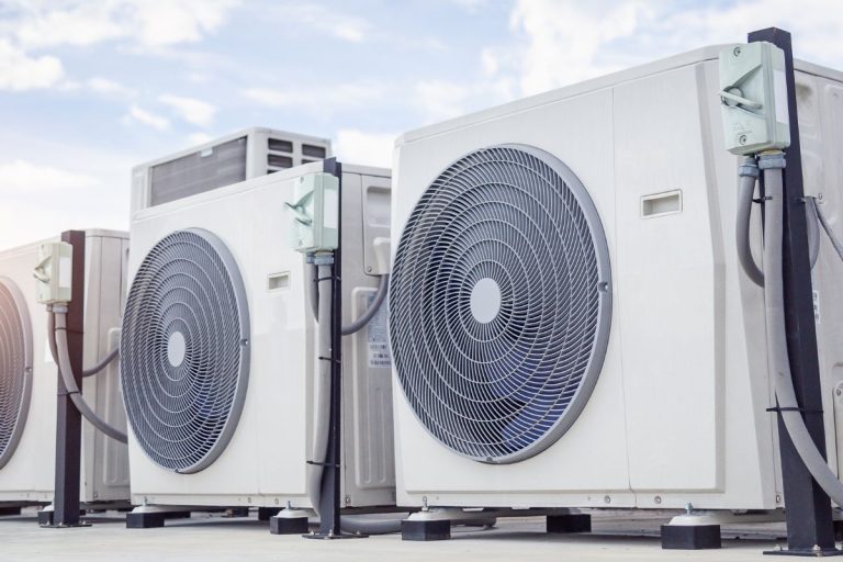 A row of air conditioning units, highlighting their role in HVAC systems to prevent mold growth.